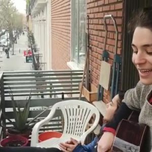 Rocío sings to her community from her balcony in Madrid, Spain.