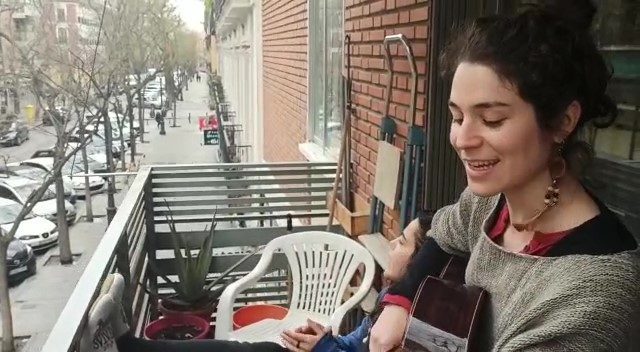 Rocío sings to her community from her balcony in Madrid, Spain.